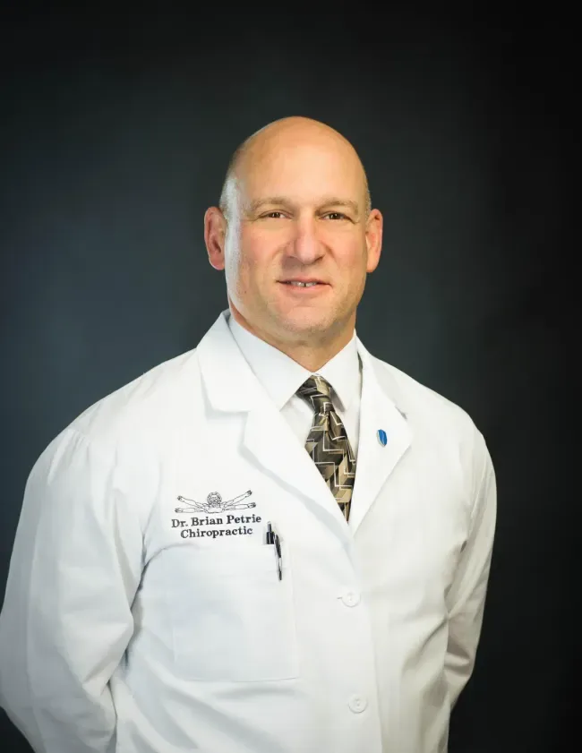Dr. Brian Petrie, DC, in his white coat